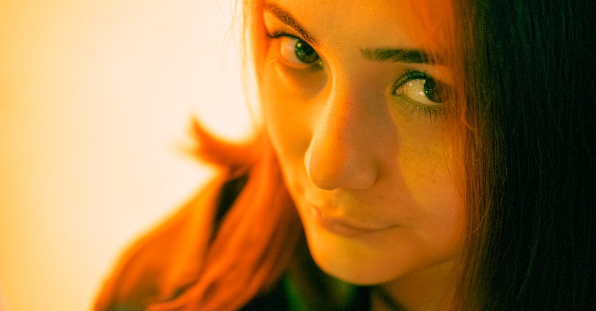 Artistic close-up portrait of a young woman with warm color grading, showcasing her expressive eyes.