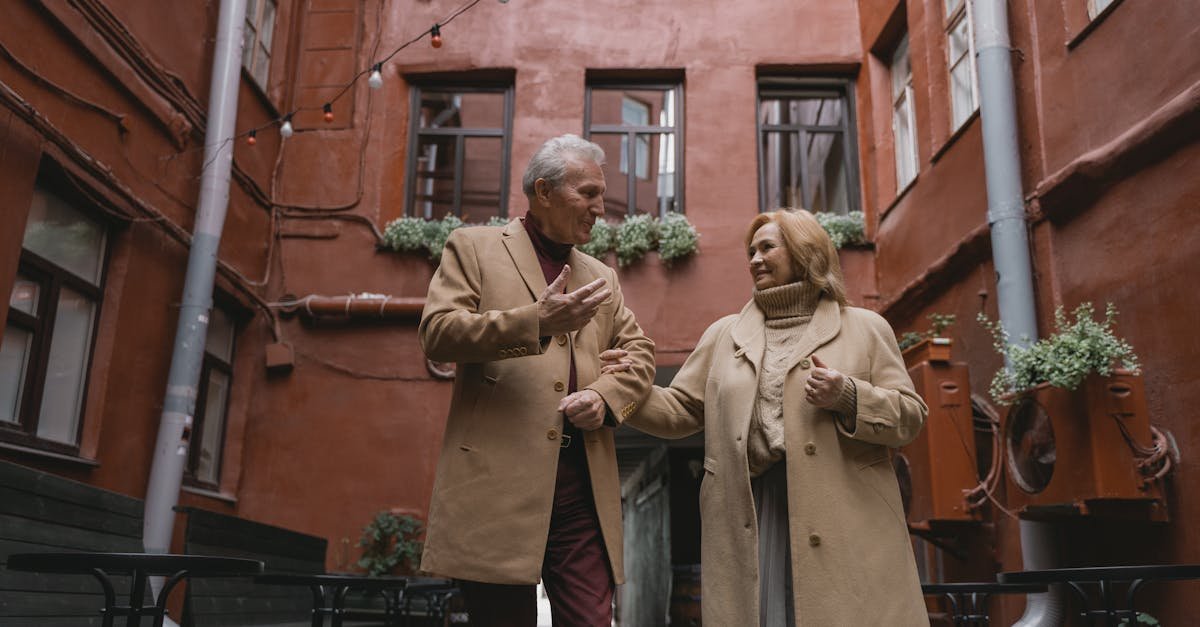 A joyous elderly couple walking hand in hand, sharing a moment in an urban setting.