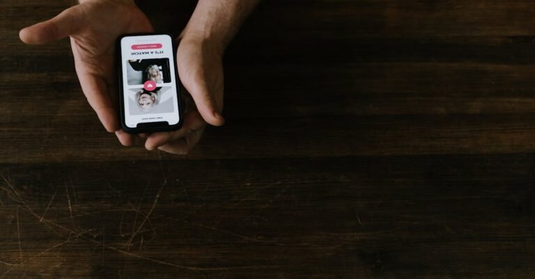 Close-up of hands holding a smartphone with a social media app open on a wooden table.