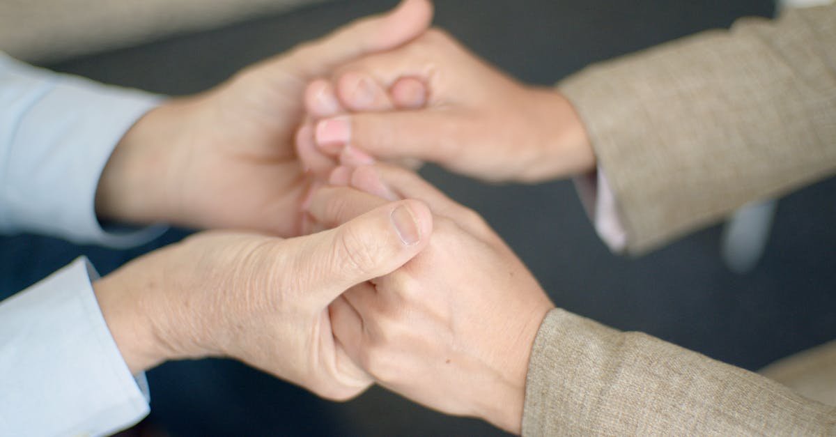 A heartfelt close-up showing a couple holding hands, symbolizing support and togetherness.